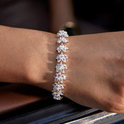 64facets diamond tennis bracelet made with lotus shaped diamonds wrapping around the wrist and set in 18k gold