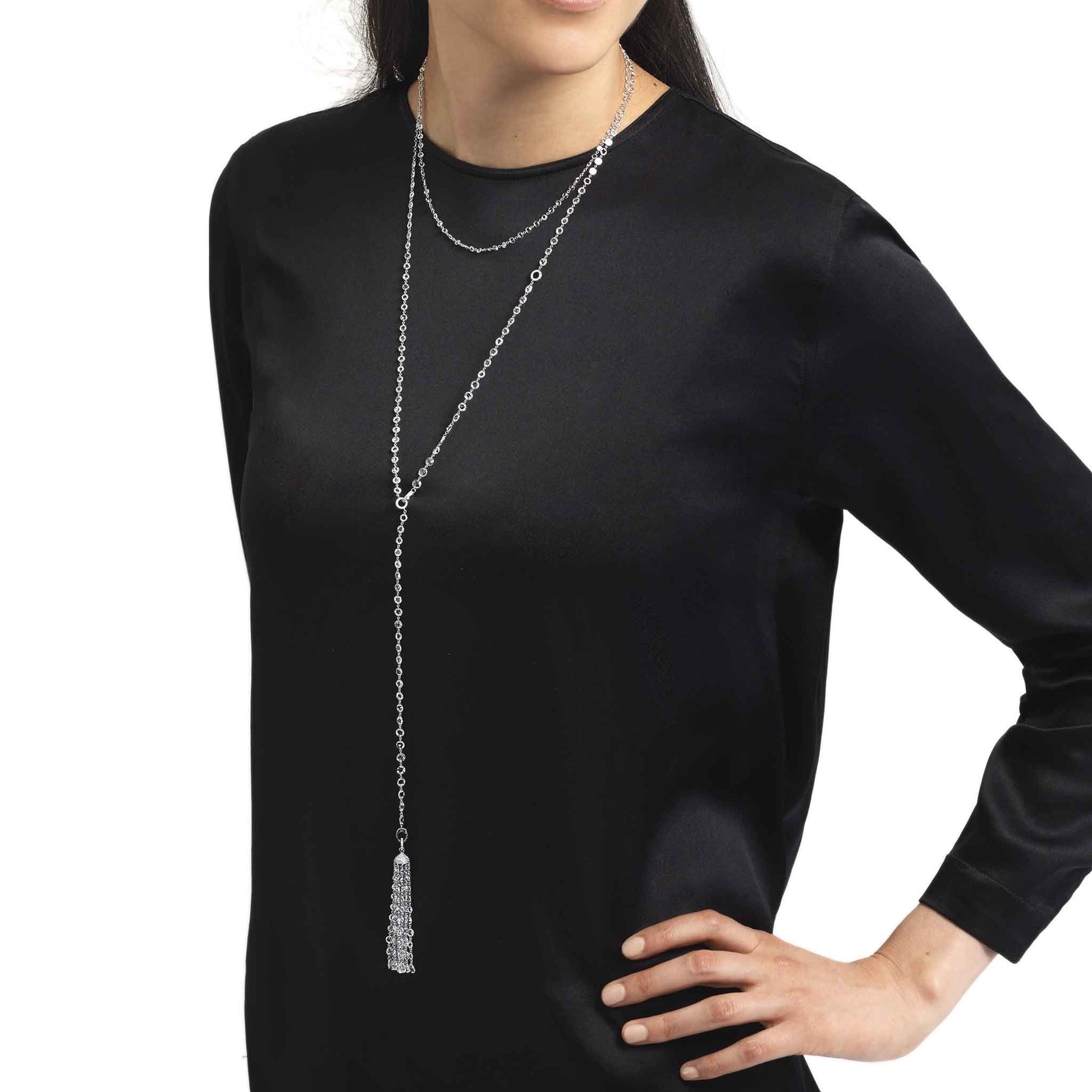Model wearing ethereal diamond tassel pendant and ethereal rose cut diamond chain necklace.