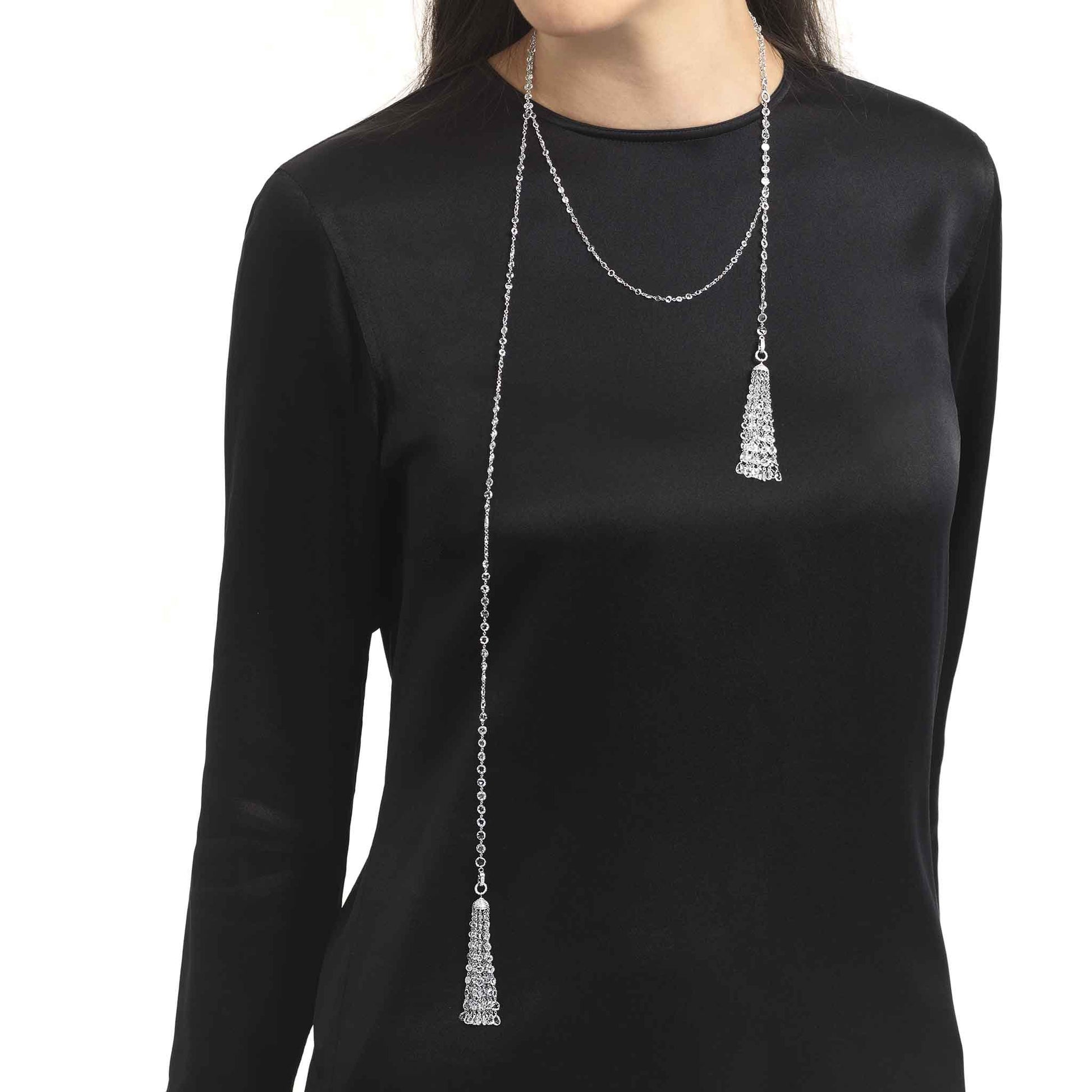 Model wearing ethereal diamond tassel pendant and ethereal rose cut diamond chain necklace.