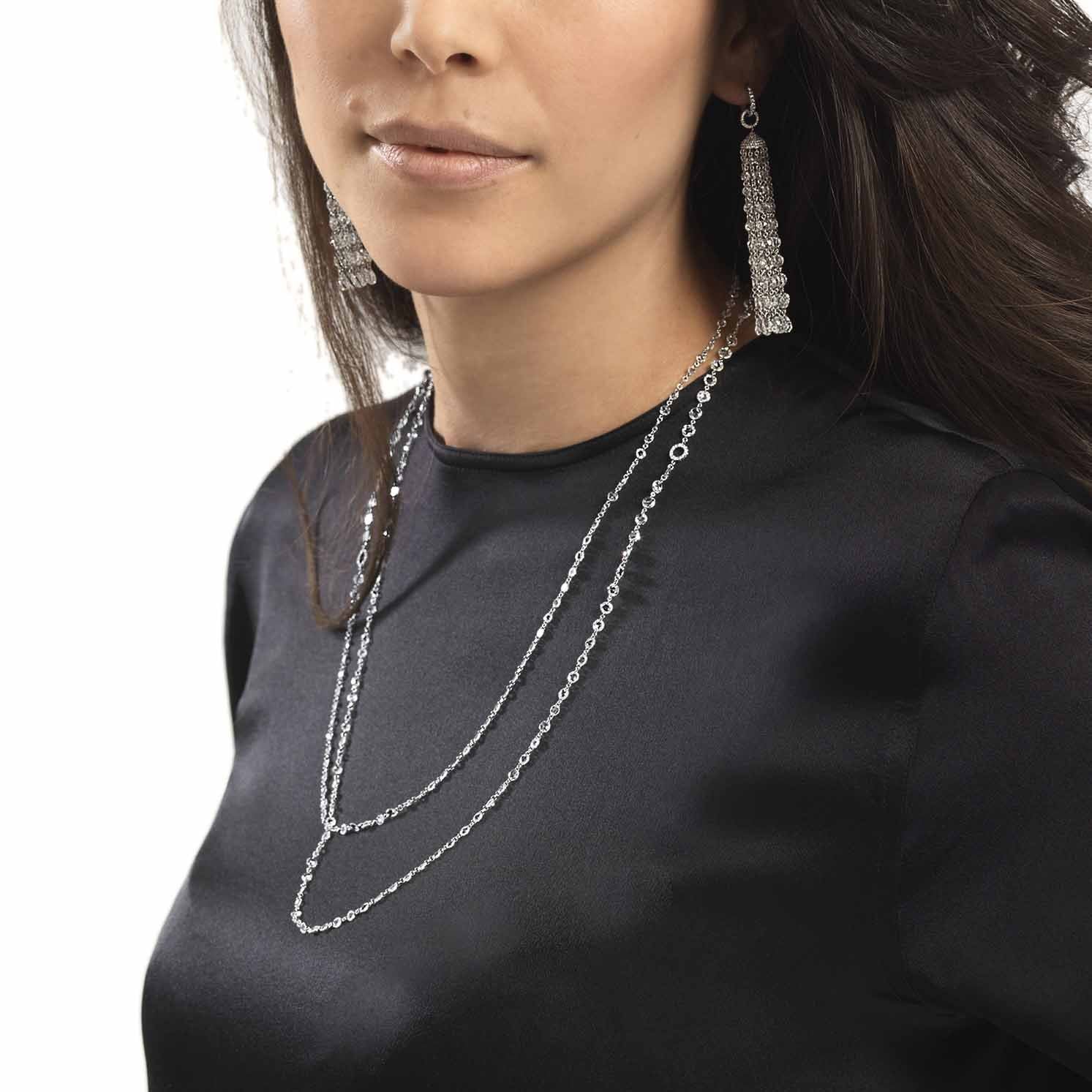Model wearing ethereal diamond tassel pendant and ethereal rose cut diamond chain necklace.