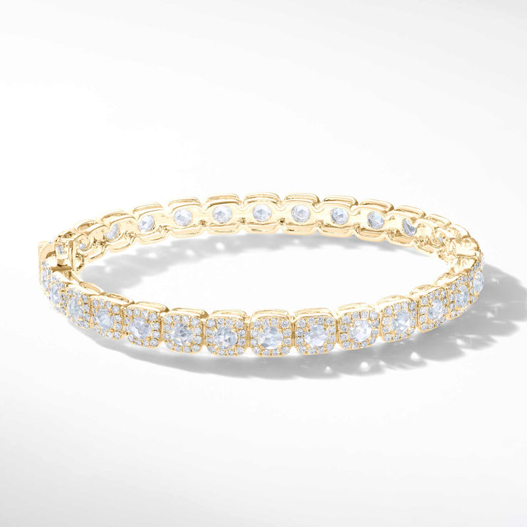 64Facets Cushion Diamond Bangle in 18K Yellow Gold. Rose Cut Diamonds are encircled i brilliant cut diamonds in a pave setting in a cushion shape. 
