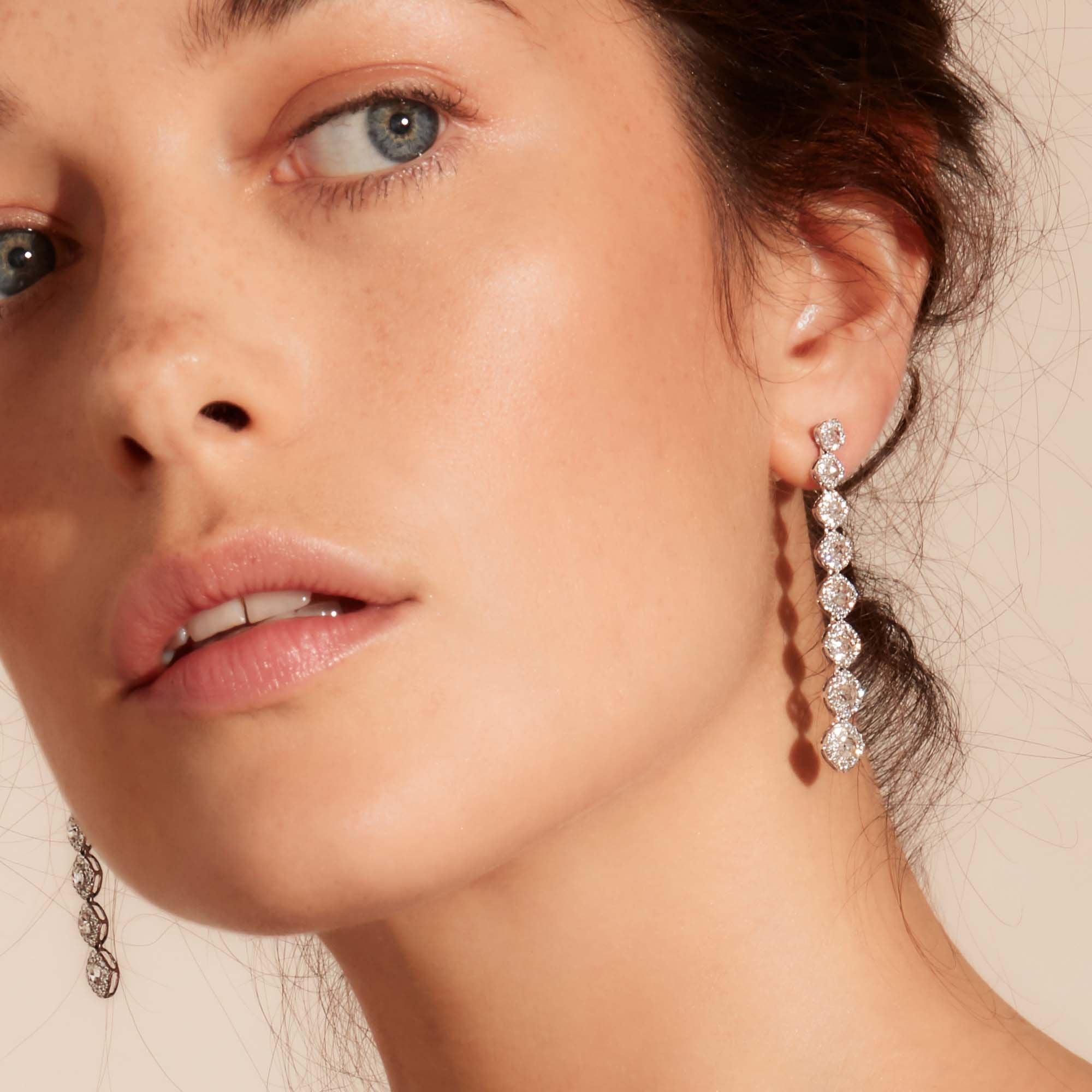 Image of Diamond dangle earrings on model. Rose cut diamonds with brilliant cut diamonds in a micro pave setting. 
