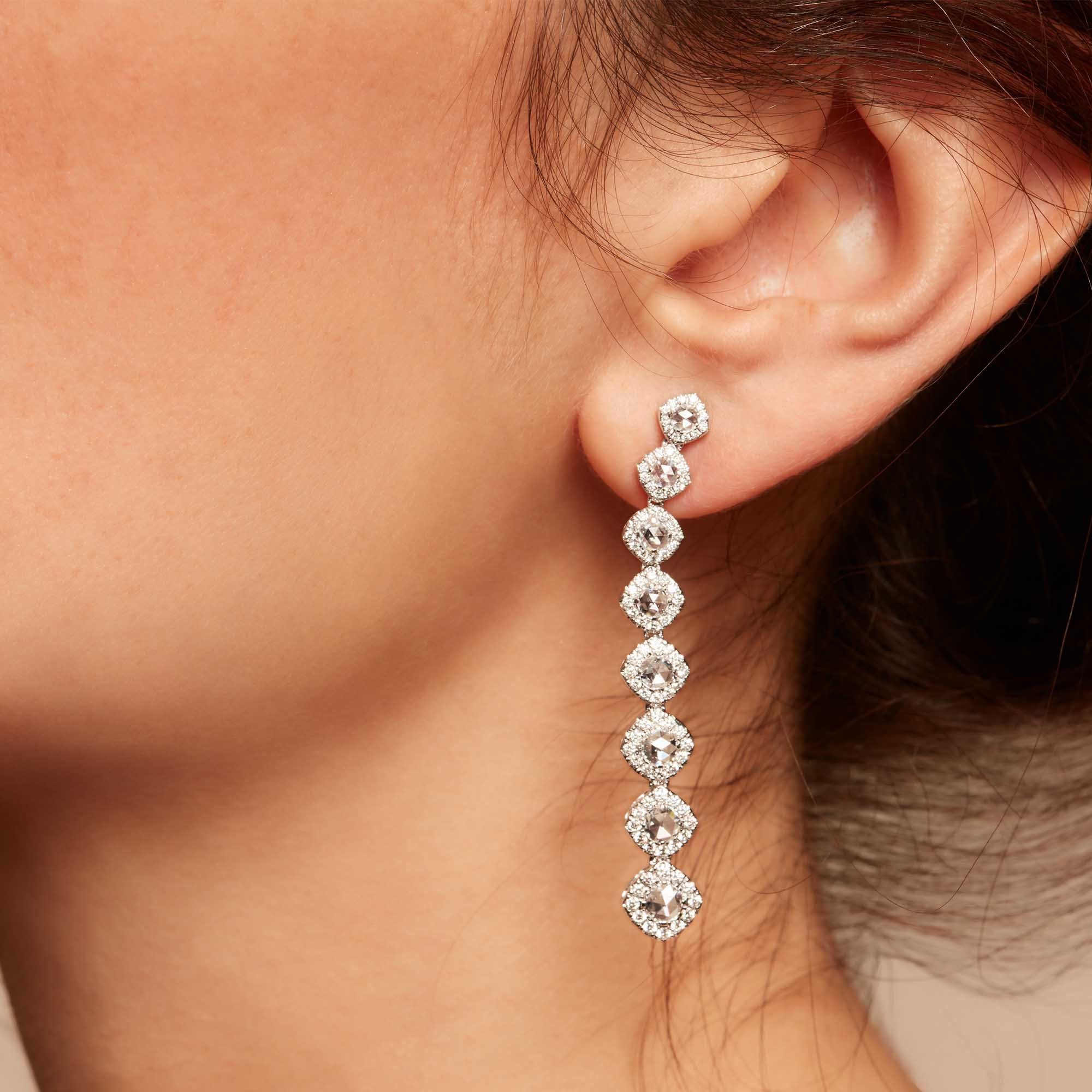 Image of Diamond dangle earrings on model. Rose cut diamonds with brilliant cut diamonds in a micro pave setting. 
