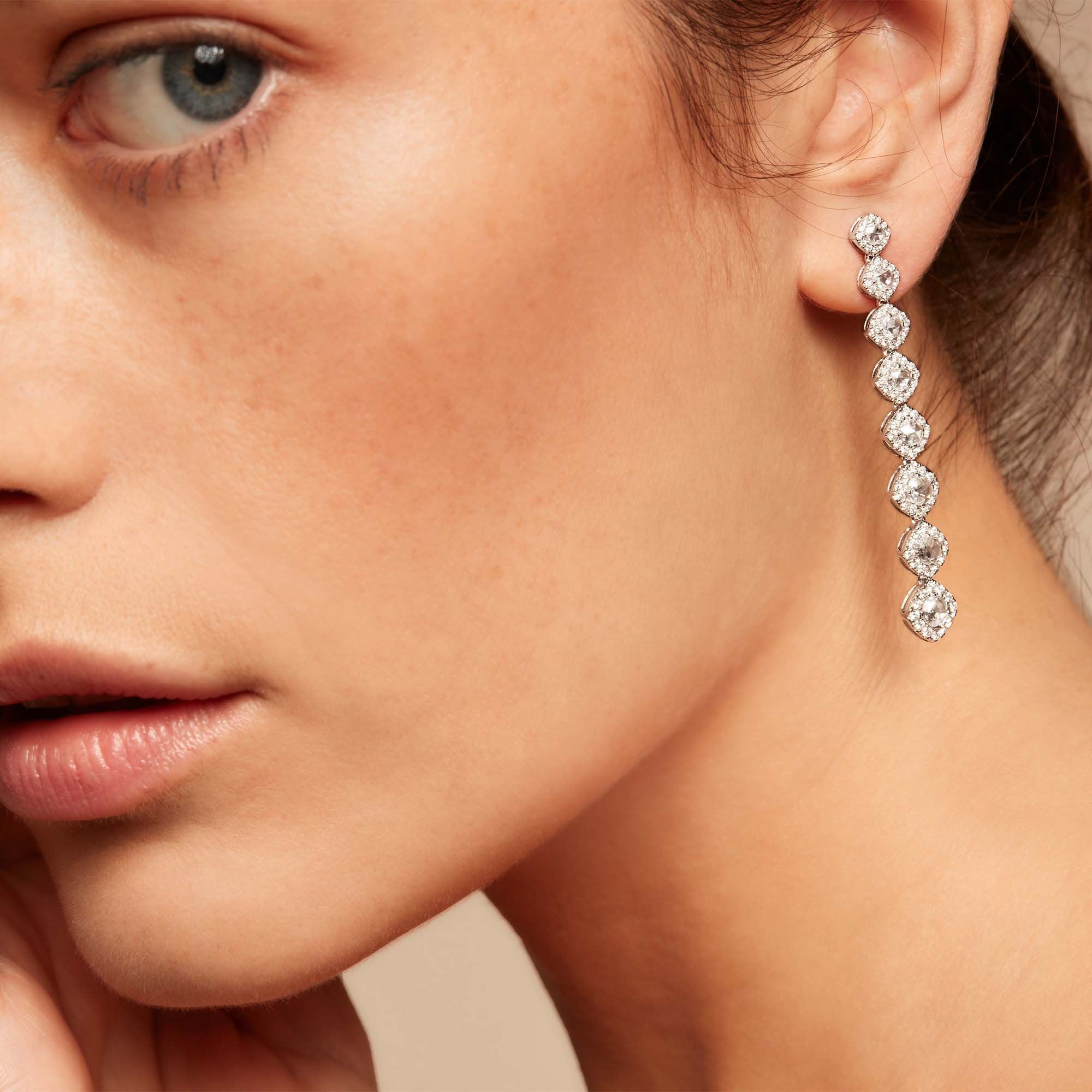 Image of Diamond dangle earrings on model. Rose cut diamonds with brilliant cut diamonds in a micro pave setting. 
