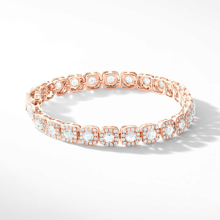 64Facets Diamond Tennis Bracelet. Rose Cut Diamonds are encircled by Pave Diamond Accents in a Cushion Motif. Set in 18K Rose Gold. 