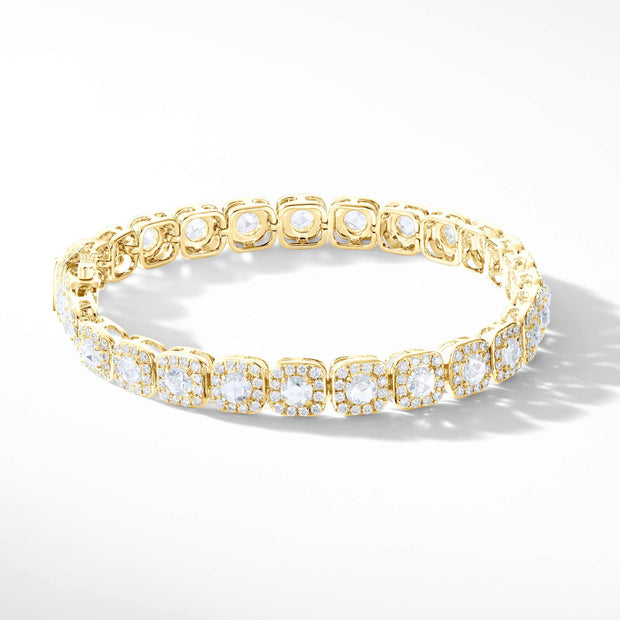 64Facets Diamond Tennis Bracelet. Rose Cut Diamonds are encircled by Pave Diamond Accents in a Cushion Motif. Set in 18K Yellow Gold. 