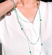 Elements diamond and cabochon necklace with emeralds, paired with our bead necklace. 64Facets 