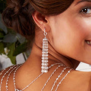 Diamond tassel earrings worn on beautiful model, close up