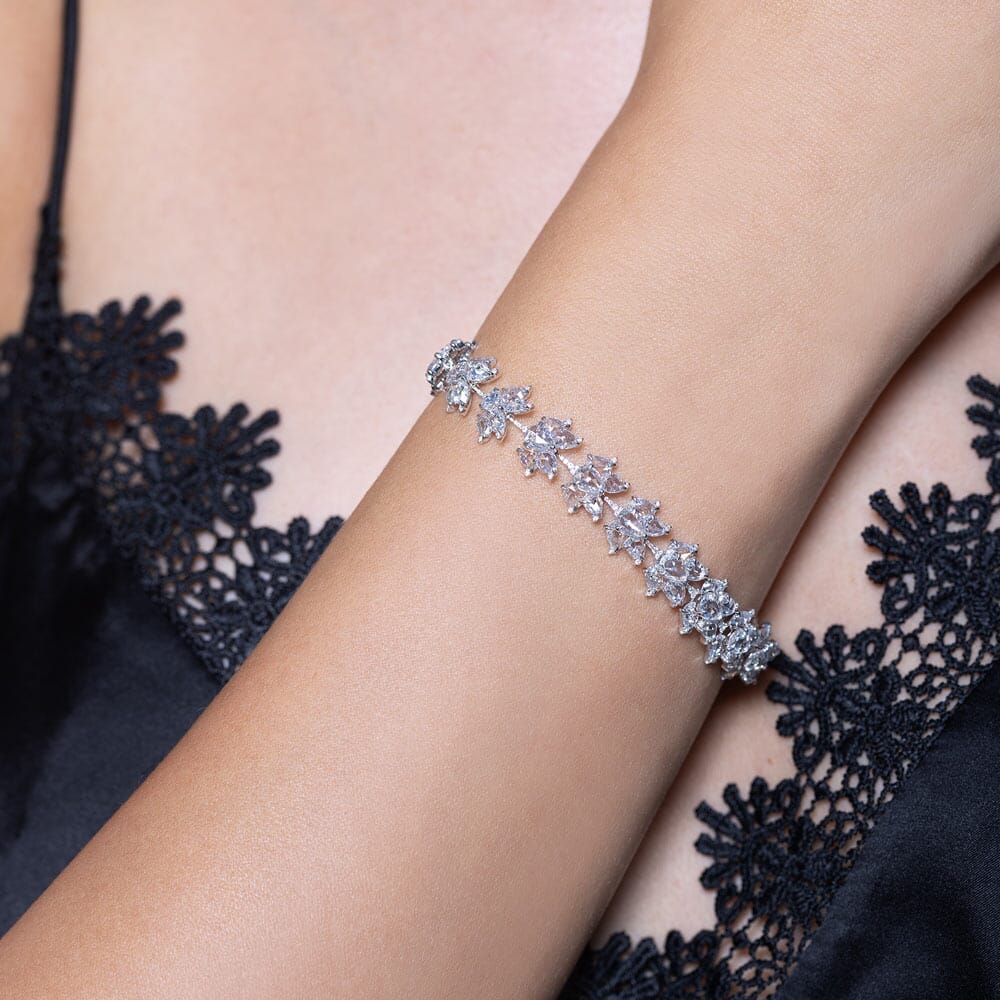 Image of 64facets diamond tennis bracelet made with lotus shaped diamonds wrapping around the wrist and set in 18k gold