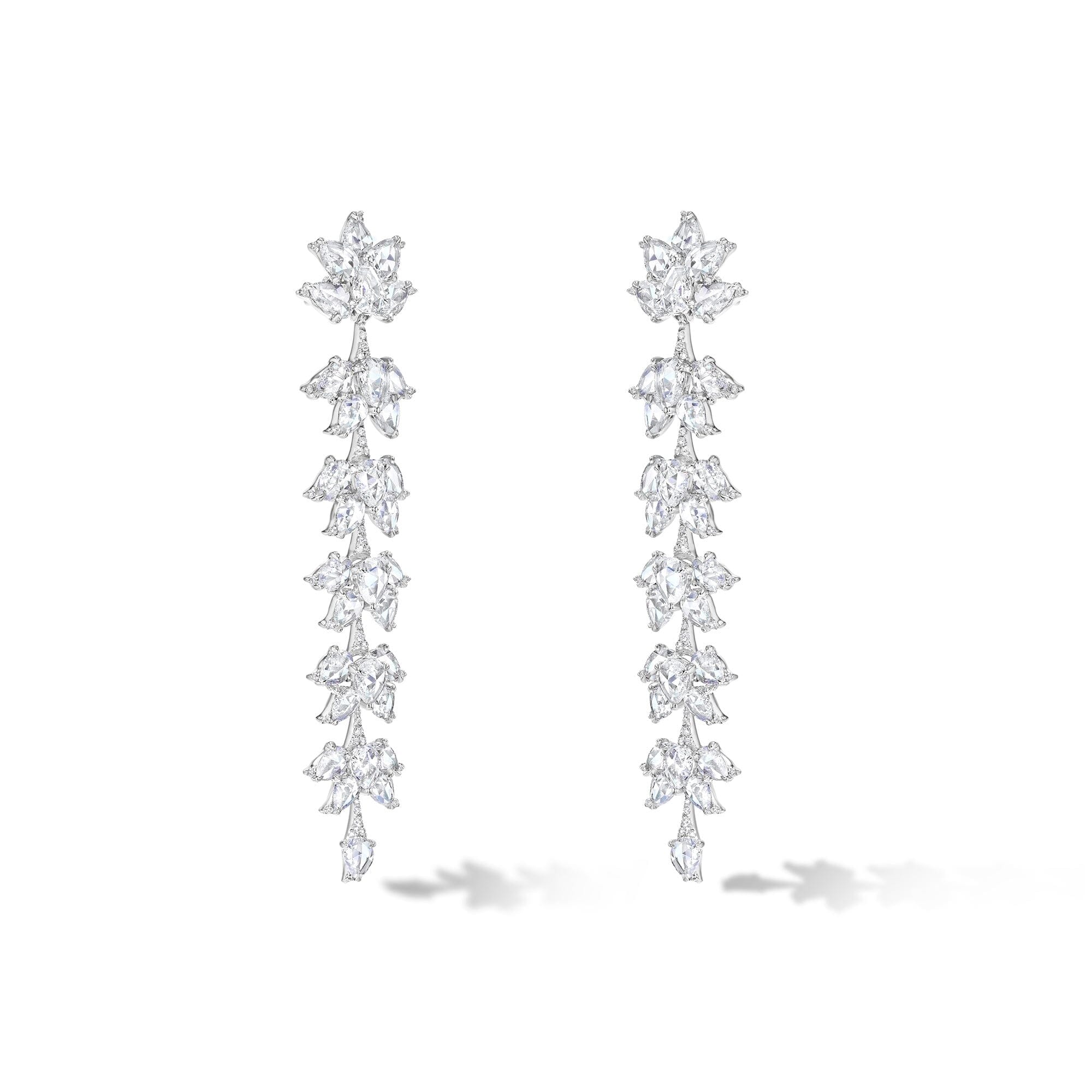 Image of 64facets diamond dangle earrings made with diamonds in the shape of lotus flowers and set in 18k gold