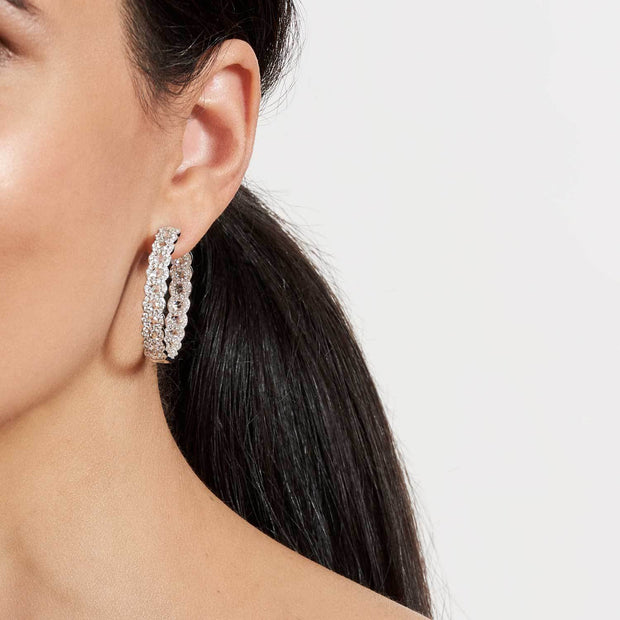 Model wearing 64Facets 18k rose gold and diamond hoop earrings. Rose cut diamonds accented by smaller brilliant cut diamonds.