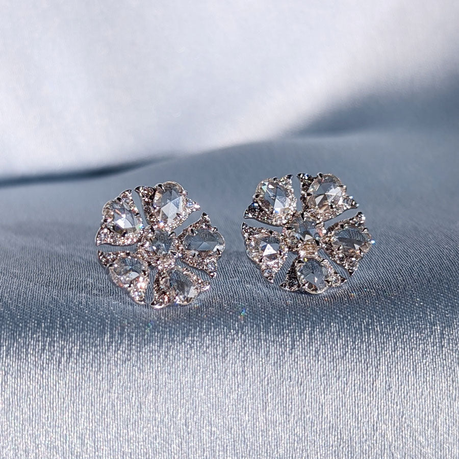 Image of 64facets rose cut diamond stud earrings in the shape of tulip flowers and set in 18k gold